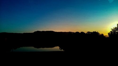 Scenic view of silhouette mountains against clear sky