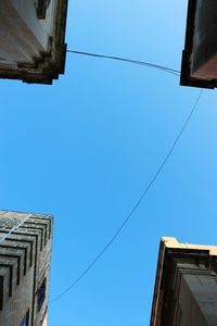 Low angle view of buildings against blue sky