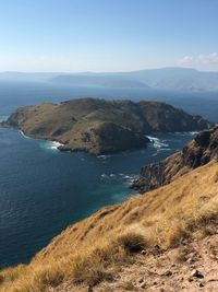 Scenic view of sea and mountains against sky