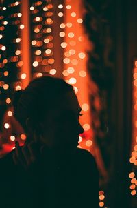 High angle view of man and woman standing by illuminated lights