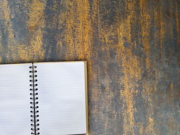 Directly above shot of open book on old wooden table