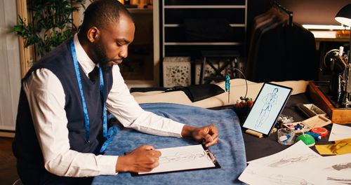 Side view of man working at table