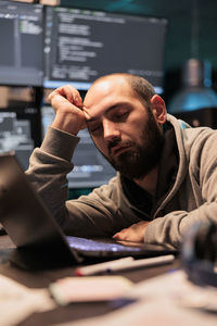 Side view of young man using mobile phone