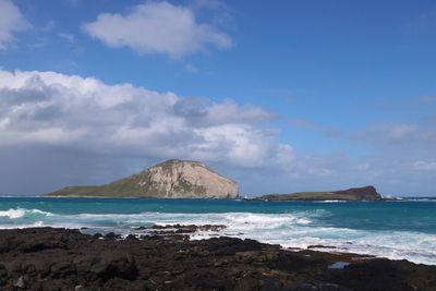 Scenic view of sea against blue sky