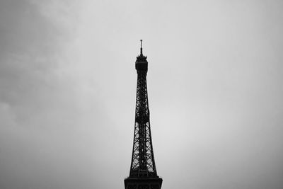 Low angle view of tower and building against sky