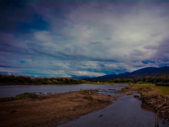 Scenic view of lake against sky at dusk