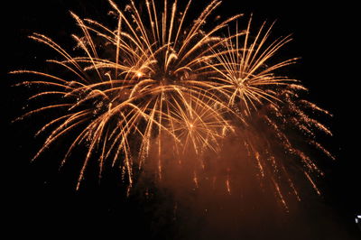 Low angle view of firework display at night