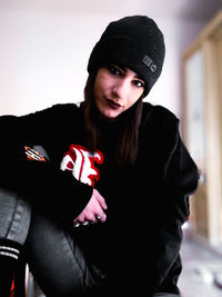 Portrait of beautiful young woman wearing hat