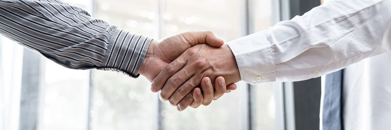 Midsection of businessman shaking hands