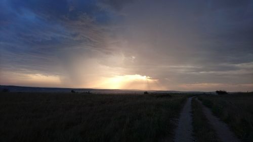 Scenic view of field against sky during sunset