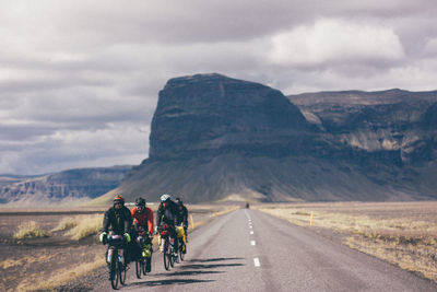 People riding motorcycle on road