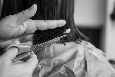 Soft focus of scissor cutting hair. close up. monochrome, black and white.