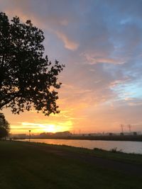 Scenic view of field against sky during sunset