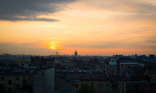 High angle view of buildings in city during sunset