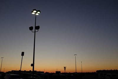 Low angle view of street lights against clear sky