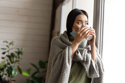 Portrait of young woman using mobile phone