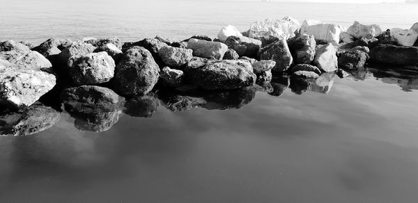 Rocks on beach against sky