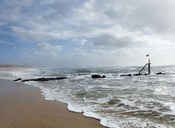 Man standing on beach against sky