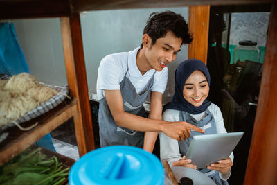 High angle view of young woman using laptop at home