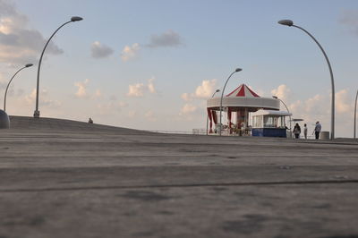 Street light against cloudy sky