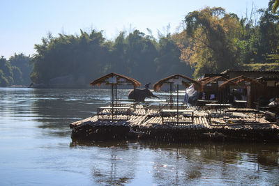 Thailand, kanchanaburi, rafts on the kwai noi river and elephants bathing in the morning