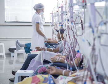 Nurse standing by patients in hospital