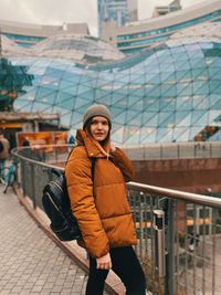 Young woman standing in city during winter