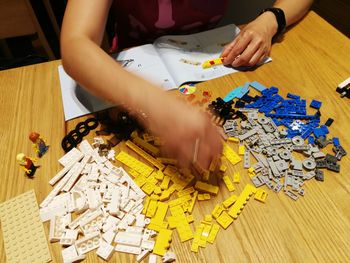 Cropped hands of woman playing with toys at home