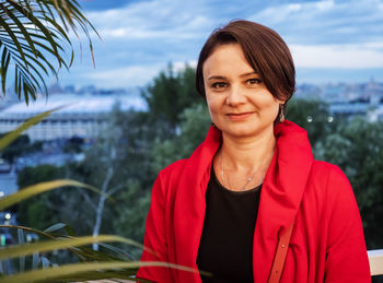 Portrait of smiling woman standing outdoors