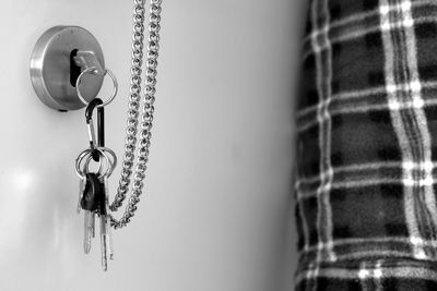 Low angle view of chain hanging against wall