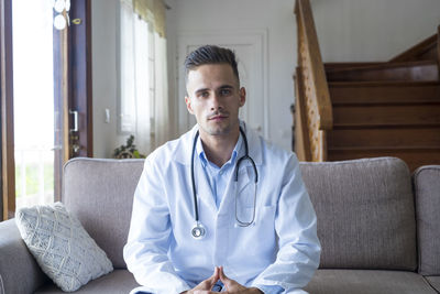 Portrait of doctor sitting on sofa