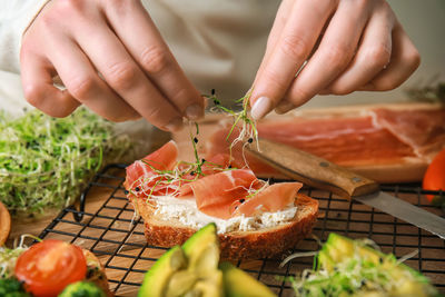 Cropped hand of person preparing food