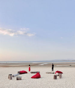 People on beach against sky