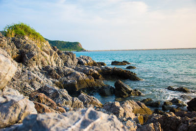 Rocks on beach against sky