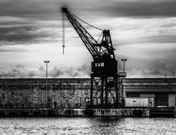 Commercial dock against cloudy sky