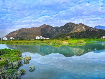 Scenic view of lake and mountains against sky