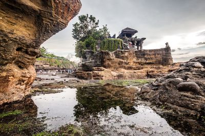 View of tanah lot rock formation against sky