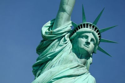 Low angle view of statue against blue sky