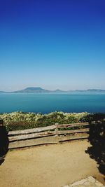 Scenic view of sea against clear blue sky