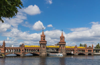 View of bridge over river against cloudy sky