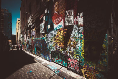 Graffiti on street amidst buildings in city