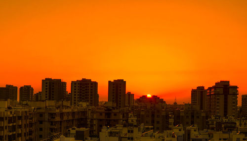 Modern buildings against clear sky during sunset