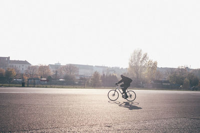 Man riding bicycle on road