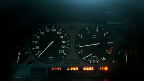 Close-up of clock on car windshield at night