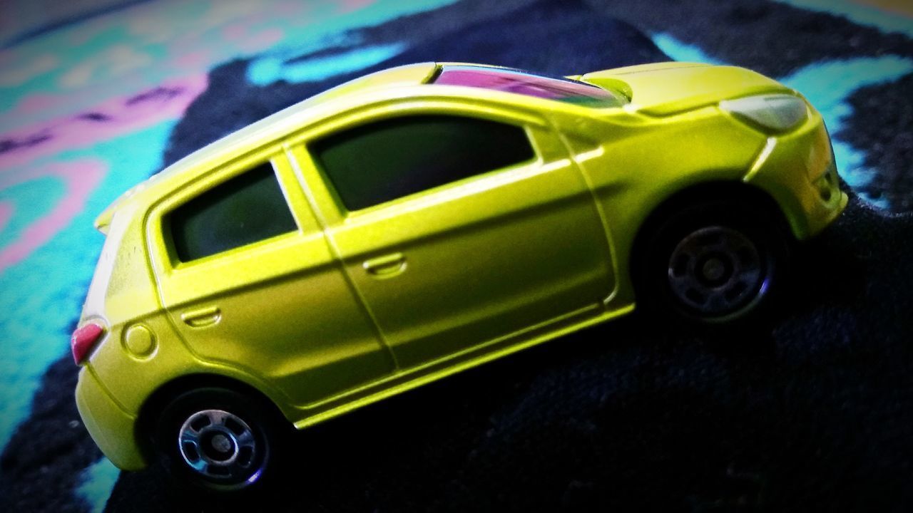 HIGH ANGLE VIEW OF YELLOW TOY CAR