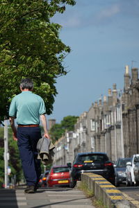 Rear view of man on street in city