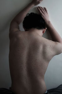 Rear view of shirtless man