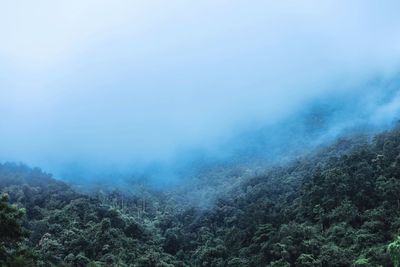 Scenic view of fog over mountains