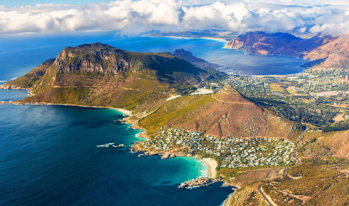 Aerial view of sea and mountains against sky