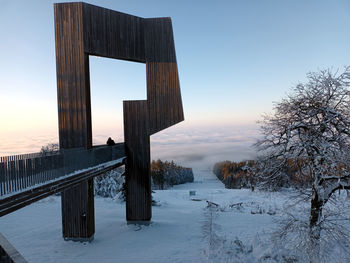 Sculpture windklang on mountain erbeskopf in hunsrueck region of  germany covered in snow.